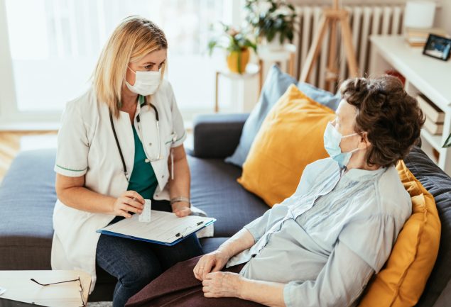 Healthcare provider speaking with long-term-care community resident