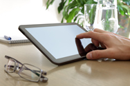 A finger touching the screen of a tablet computer