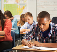 A group of high school students studying in a classroom.