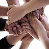 A group of hands stacked together.