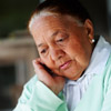 Older American Indian woman looking down