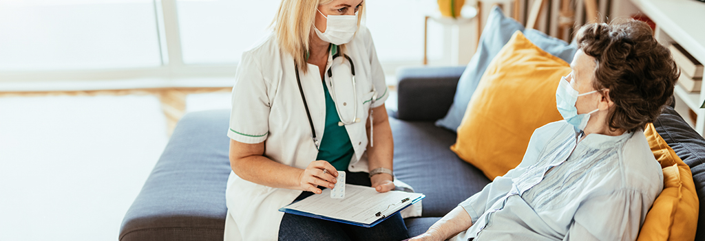 Health care provider talking to long-term-care community resident