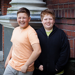 Two boys laughing and smiling.