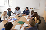 A counselor leads a discussion among a group of students.