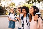 A group of college students walking across campus.