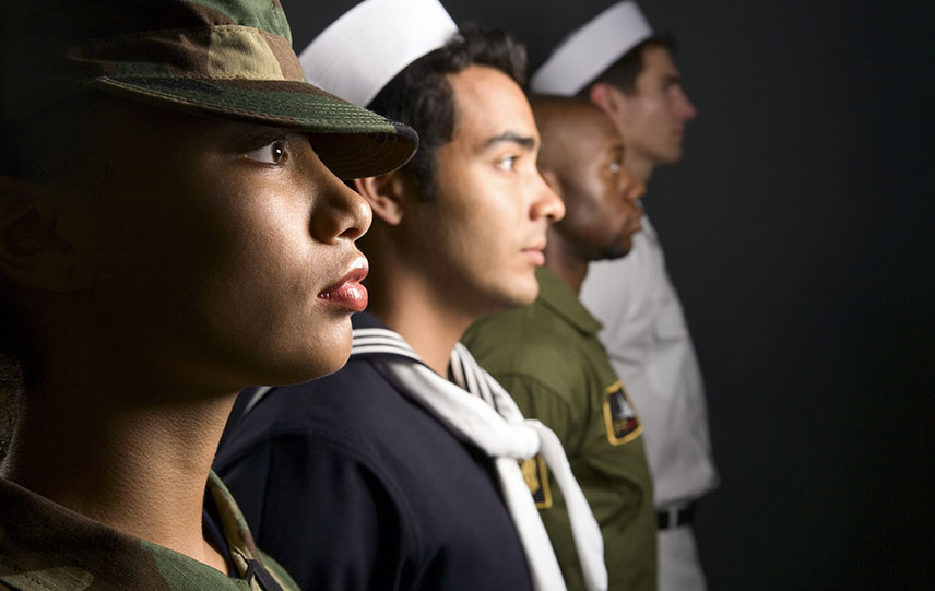 A group of four U.S. military members standing at attention.