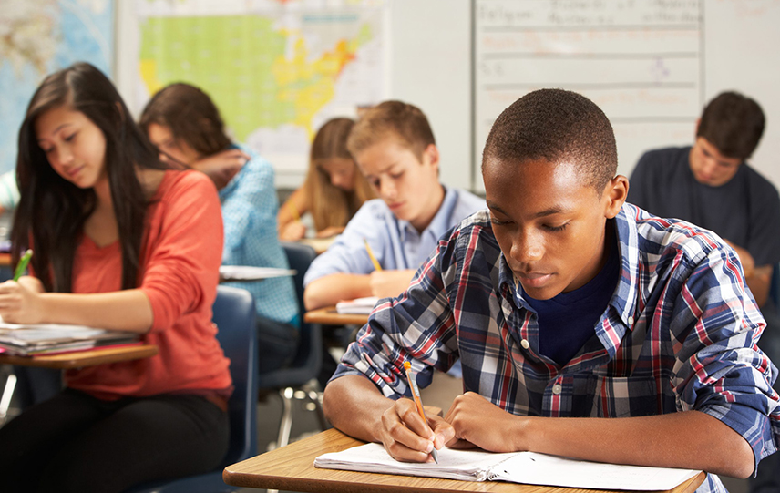 A group of high school students study in a classroom